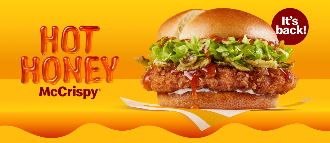 A chicken sandwich made with crispy jalapeños and dripping hot honey sauce. Beside it are the words, “It’s back!”. 