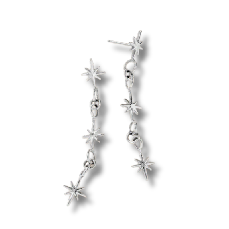 While gold dangle earrings with stars