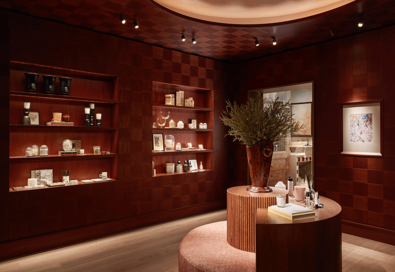 Diptyque store interior with dark wood walls, shelves, and a circular bench in the middle